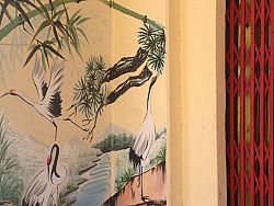 Takua Pa street scenes include intricately painted murals, cute places to take photographs and market vendors