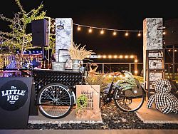 Adorable cocktail carts serve up a wide variety of refreshments for those enjoying a bit of market shopping.