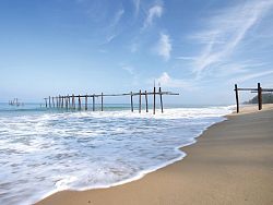The old, wooden Natai Beach bridge is a popular attraction in the area