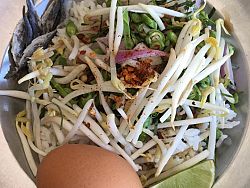Khao yum is a rice salad of sorts filledwith fresh vegetables and lemongrass. It is a light, refreshing breakfast