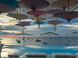 Impressive
line-up of superyachts with Thai umbrellas and a spectacular Phuket sunset in
the background