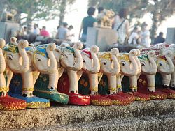 The Elephant Shrine at Promthep Cape is lined with various elephant statues and carvings